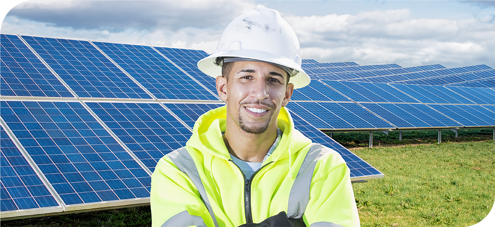 Image of a solar installer standing in front of a solar field
