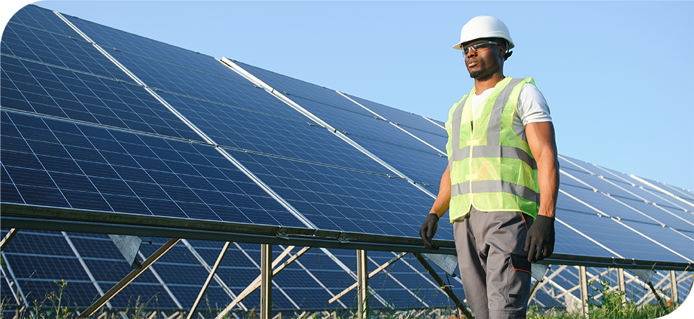 Image of a solar photovoltaic installer walking through a solar field